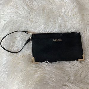 New without tags Calvin Klein black with gold accent wristlet.